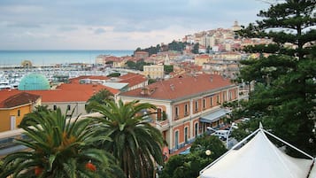 Un paisaje urbano costero con edificios históricos, un puerto deportivo y una iglesia destacada.