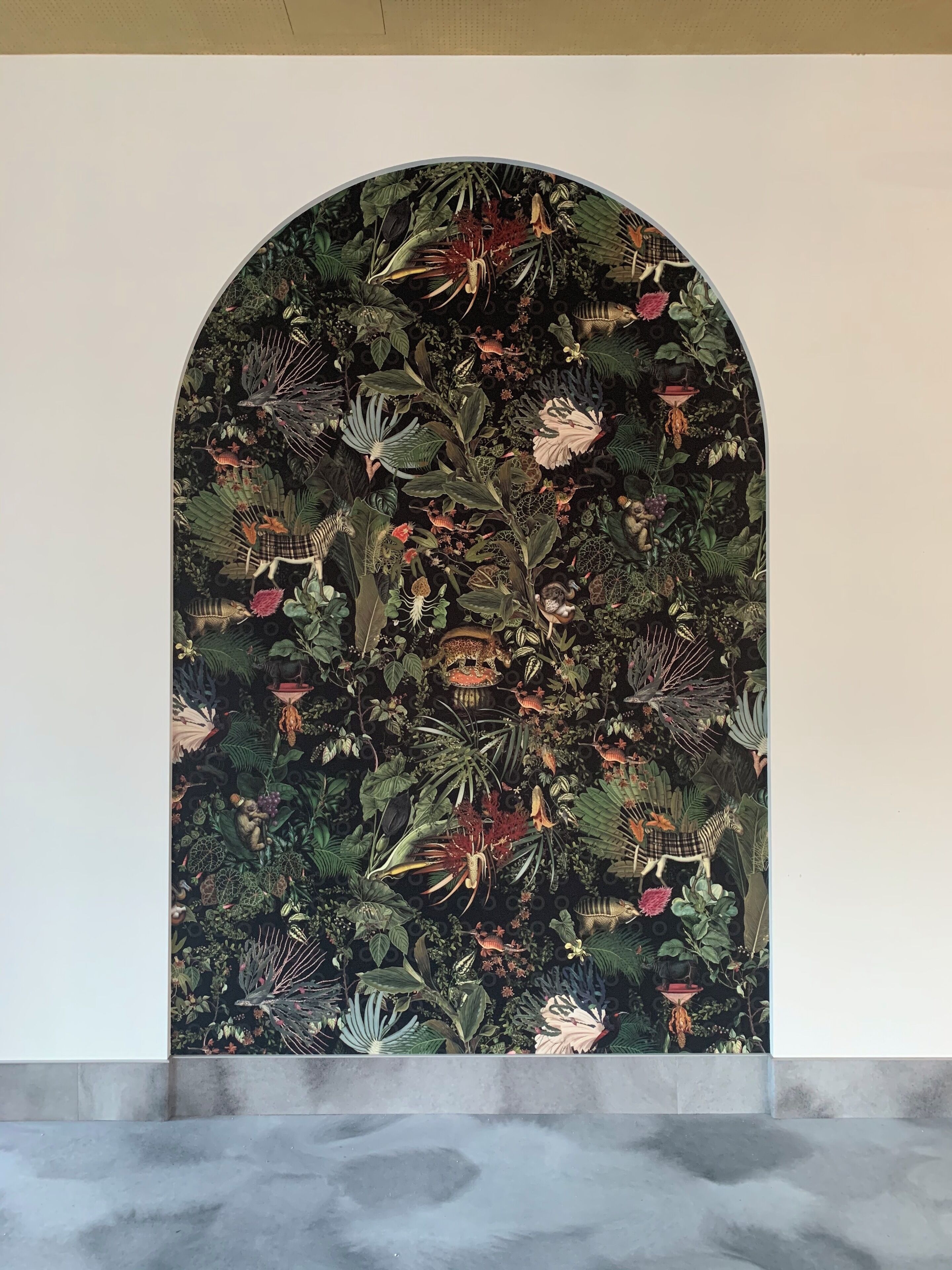 A wall with a detailed botanical mural.