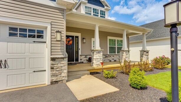 A two-story house with a garage, a covered porch, and a stone foundation. - Home ~ 3 Mi to Penn State: Pets Welcome! (State College)