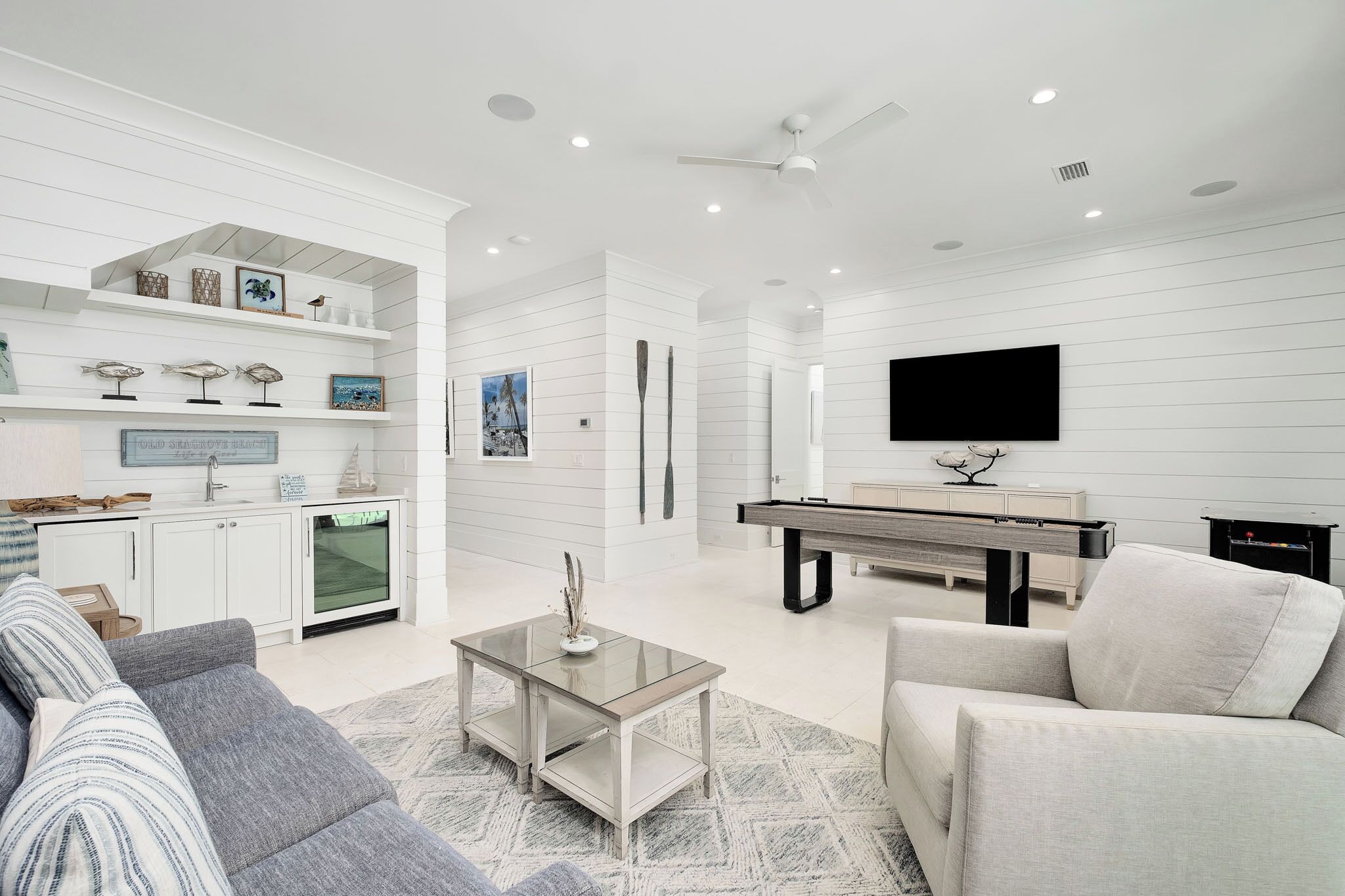 A modern living room with a sofa, coffee table, and a flat-screen TV.