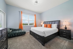 A bedroom with a bed, nightstands, a dresser, and a window with curtains.