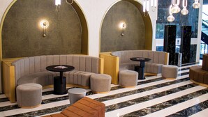 A modern lounge area with curved seating, pendant lighting, and a marble floor. - Sam Royal Hotel (Eskisehir)