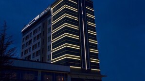 A high-rise hotel with a modern design, featuring illuminated lines on the facade and a prominent 'Sam Royal' sign. - Sam Royal Hotel (Eskisehir)