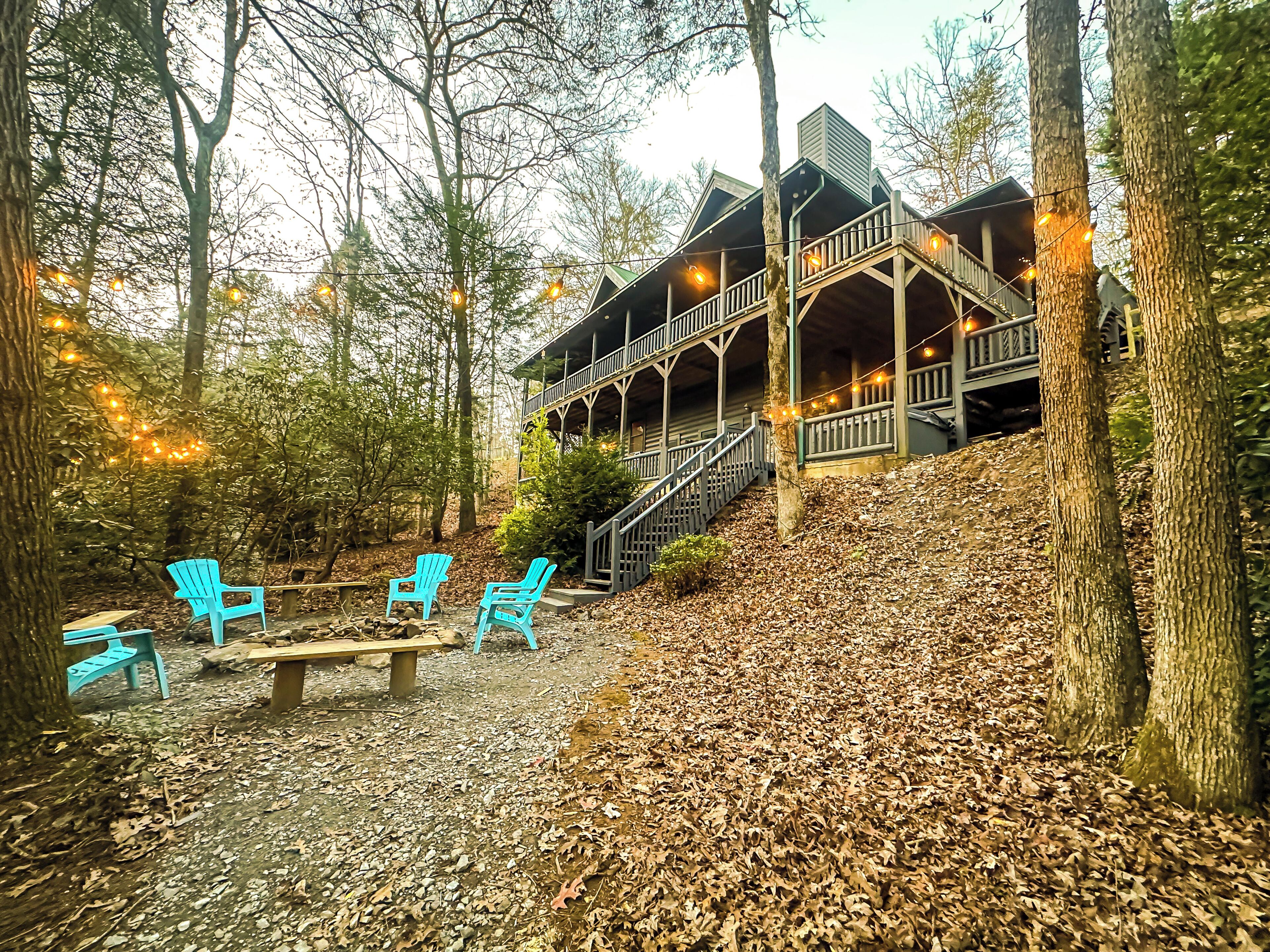 A cabin with a porch and outdoor seating area.