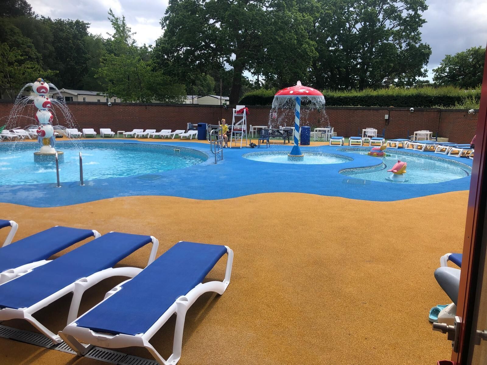A water park with multiple pools, water slides, and lounge chairs.