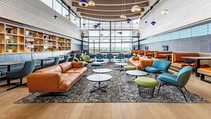 A modern interior with seating areas, tables, and a large window. - THE SPACE TO STAY APARTHOTEL (St. Andrews)
