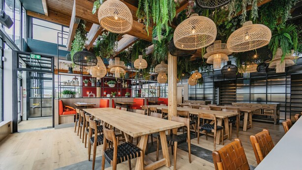 A restaurant with wooden tables and chairs, hanging rattan lamps, and indoor plants. - THE SPACE TO STAY APARTHOTEL (St. Andrews)