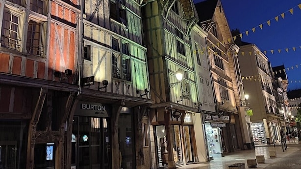 Eine historische Straße mit traditioneller Bebauung, darunter ein Burton Geschäft.