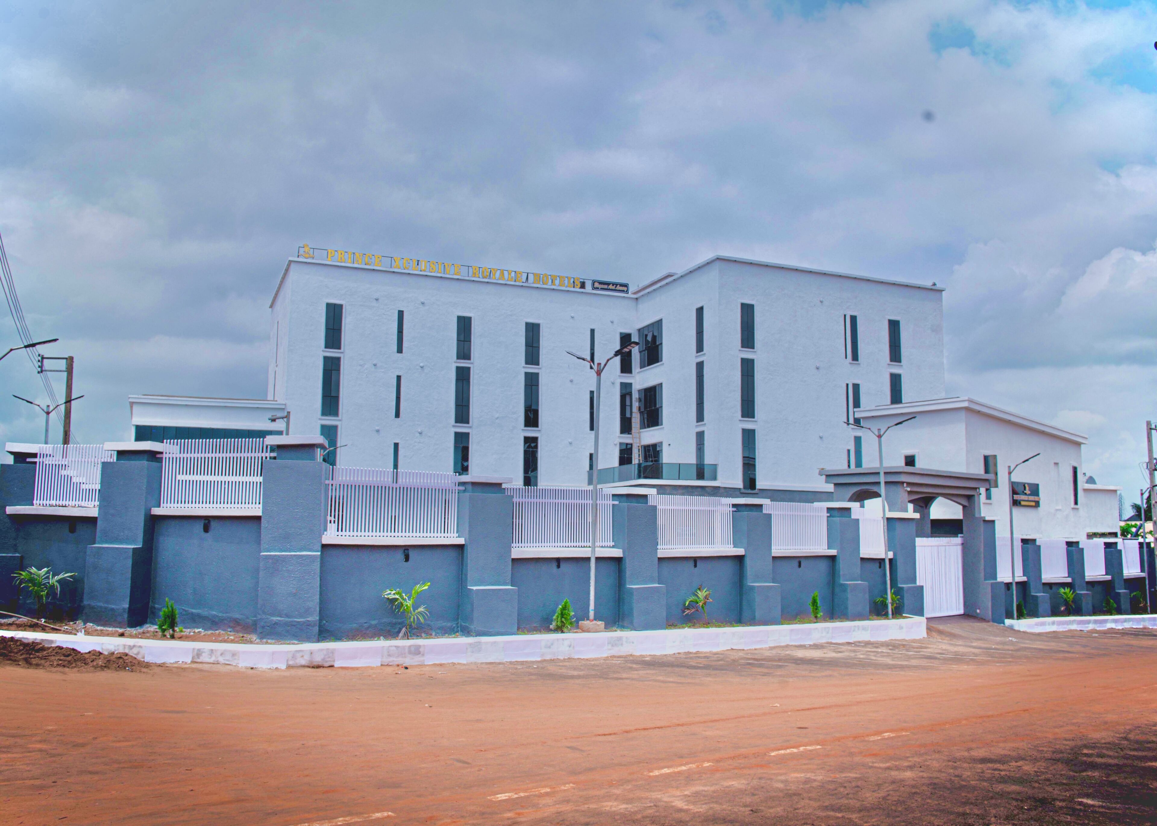 A large, modern building with a white facade and multiple windows.