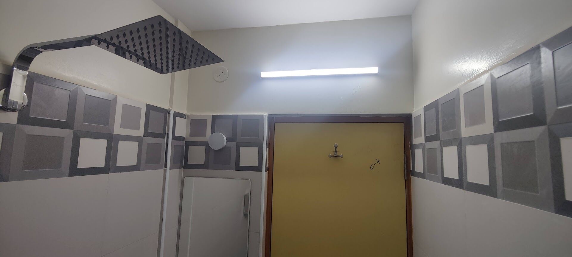 A bathroom with a shower, a toilet, and a sink.