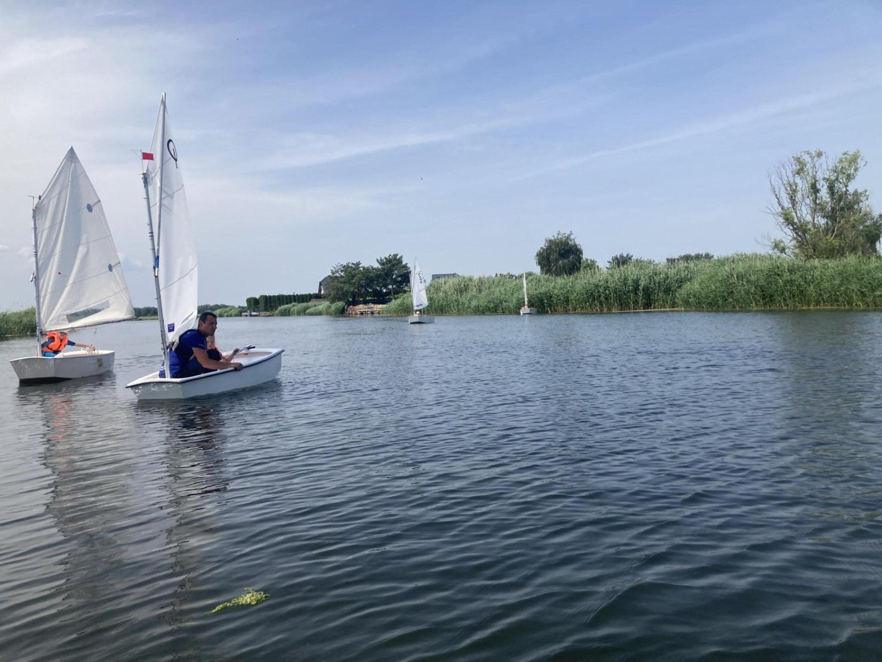 A calm river with sailboats.