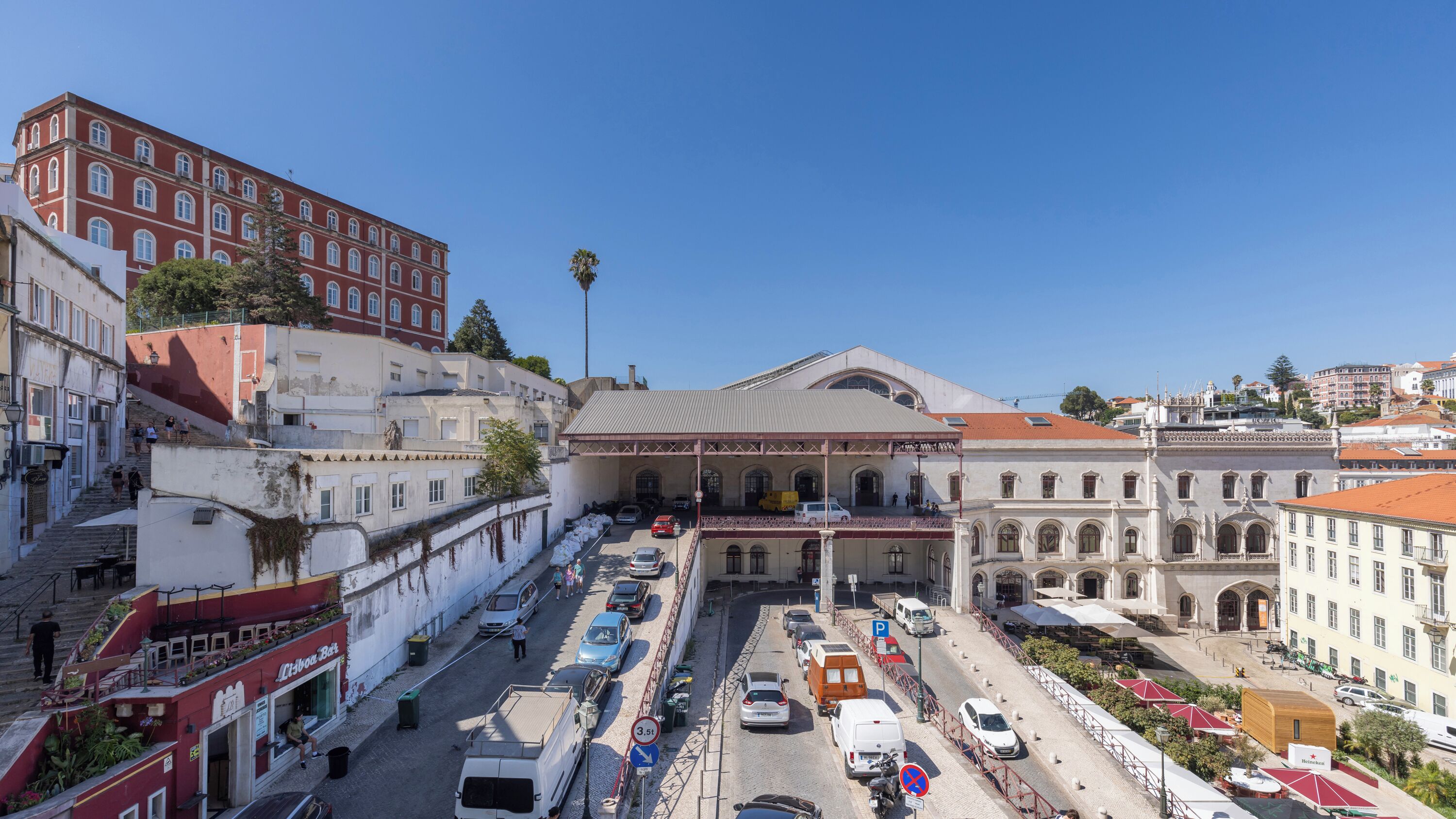 A historic building with a central courtyard, surrounded by modern buildings and a busy street.