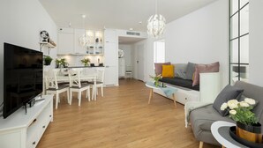 A modern living space with a dining area, kitchen, and seating area. - Apartment Close to the Sea, With Pool and Sauna (Rewal)