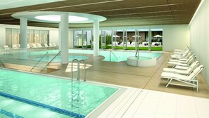 A modern indoor swimming pool area with multiple pools, lounge chairs, and a covered seating area. - Apartment Close to the Sea, With Pool and Sauna (Rewal)
