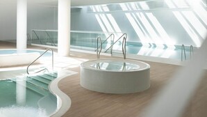 A modern indoor pool area with a circular hot tub, a rectangular pool, and a glass railing. - Apartment in Pobierowo Near Baltic Beach (Rewal)