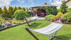 A garden with two hammocks and a gazebo. - Comfortable Holiday Home With Garden, by the Lake (gmina Będzino)