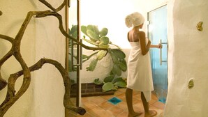 A person in a white towel standing at a door, a cactus plant is visible in the background. - Apartment in Holiday Complex Only 100 m From the Beach (Golfo Aranci)