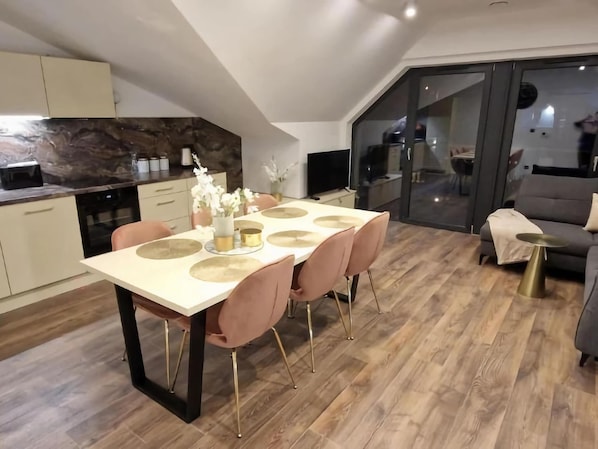 A modern dining area with a table set for four, surrounded by chairs with gold legs. - Apartment, Beautiful View, Szklarska Poreba (Szklarska Poreba)