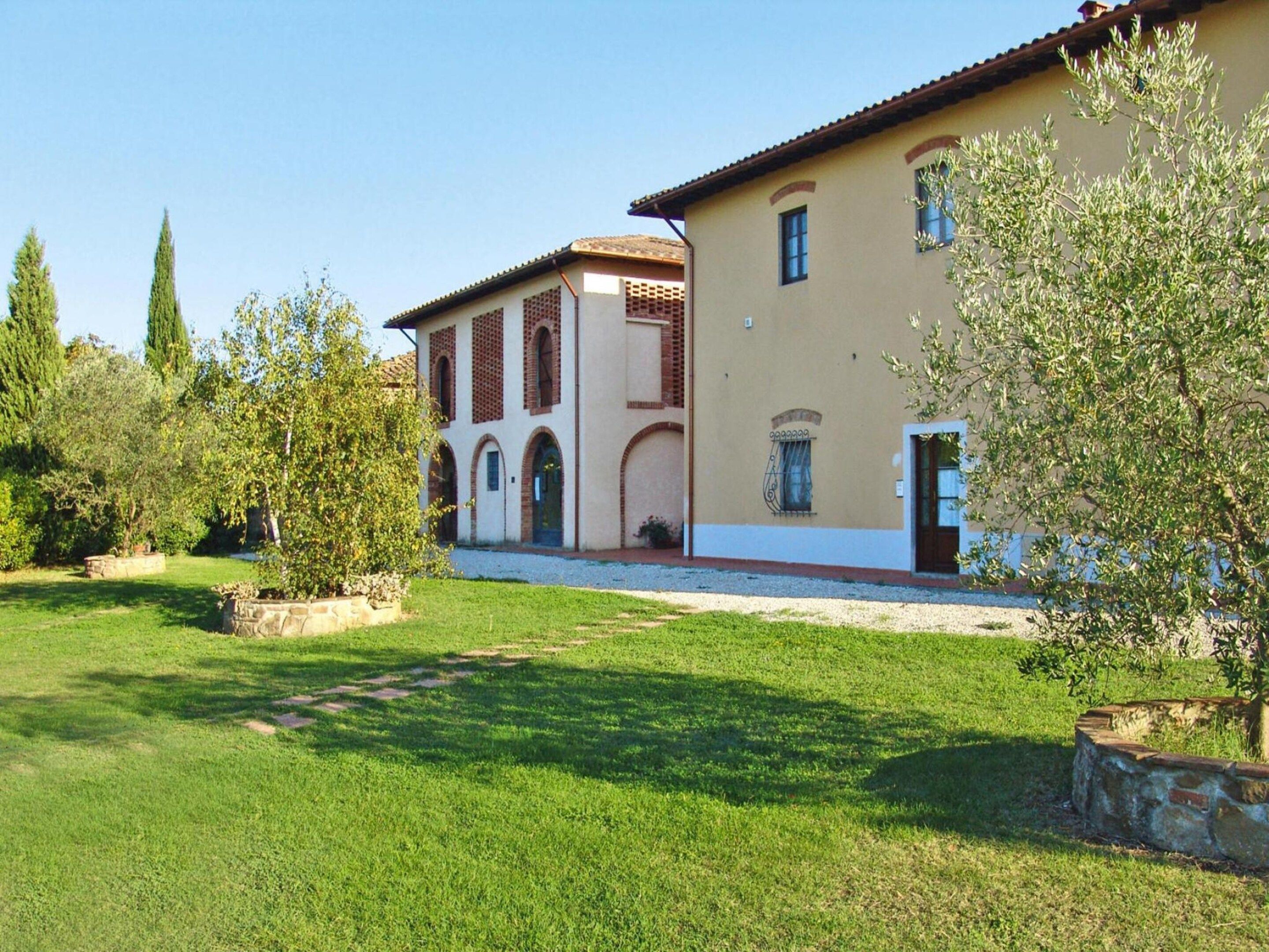 A two-story building with a garden in front.