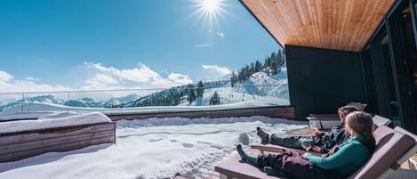 A wooden deck with a view of a snowy mountain landscape.