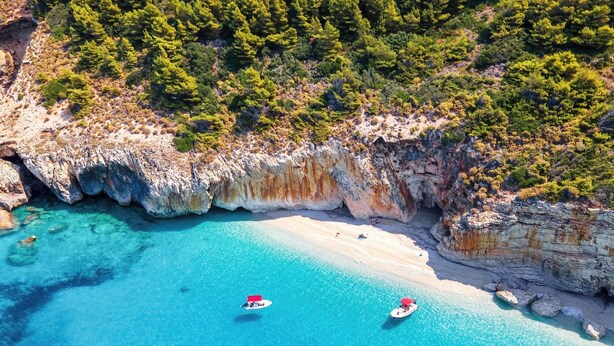 An aerial view of a coastal area with clear turquoise waters, rocky cliffs, and a sandy beach. - Villa Mansion With Private Pool (Zakynthos)