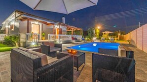A poolside area with outdoor furniture, a covered seating area, and a swimming pool. - Villa Mansion With Private Pool (Zakynthos)
