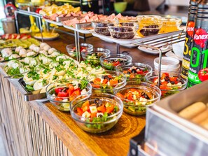A buffet with various food items including salads, meats, and dips. - Comfortable Holiday Homes, Summer Pool, Sauna (Rewal)