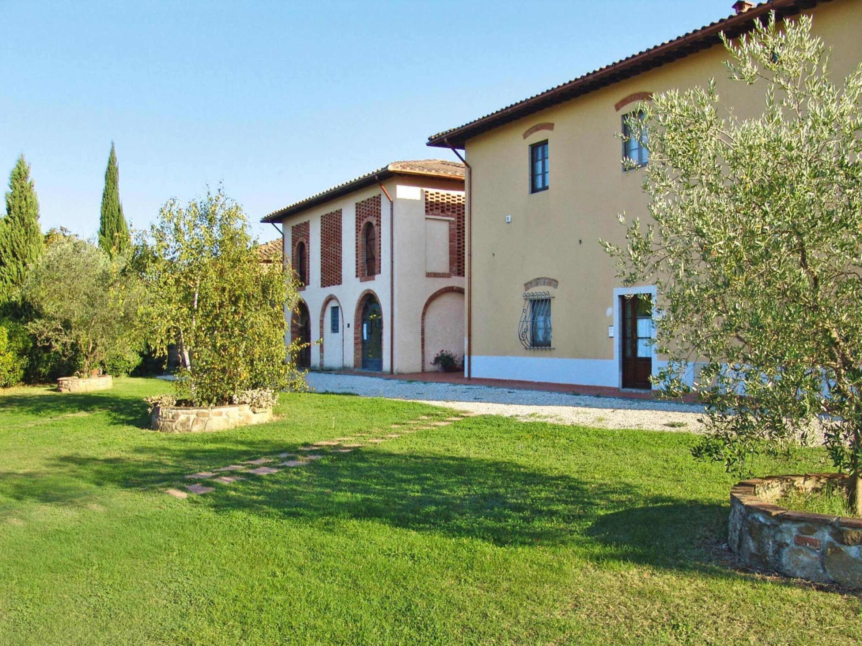 A two-story building with a garden in front.