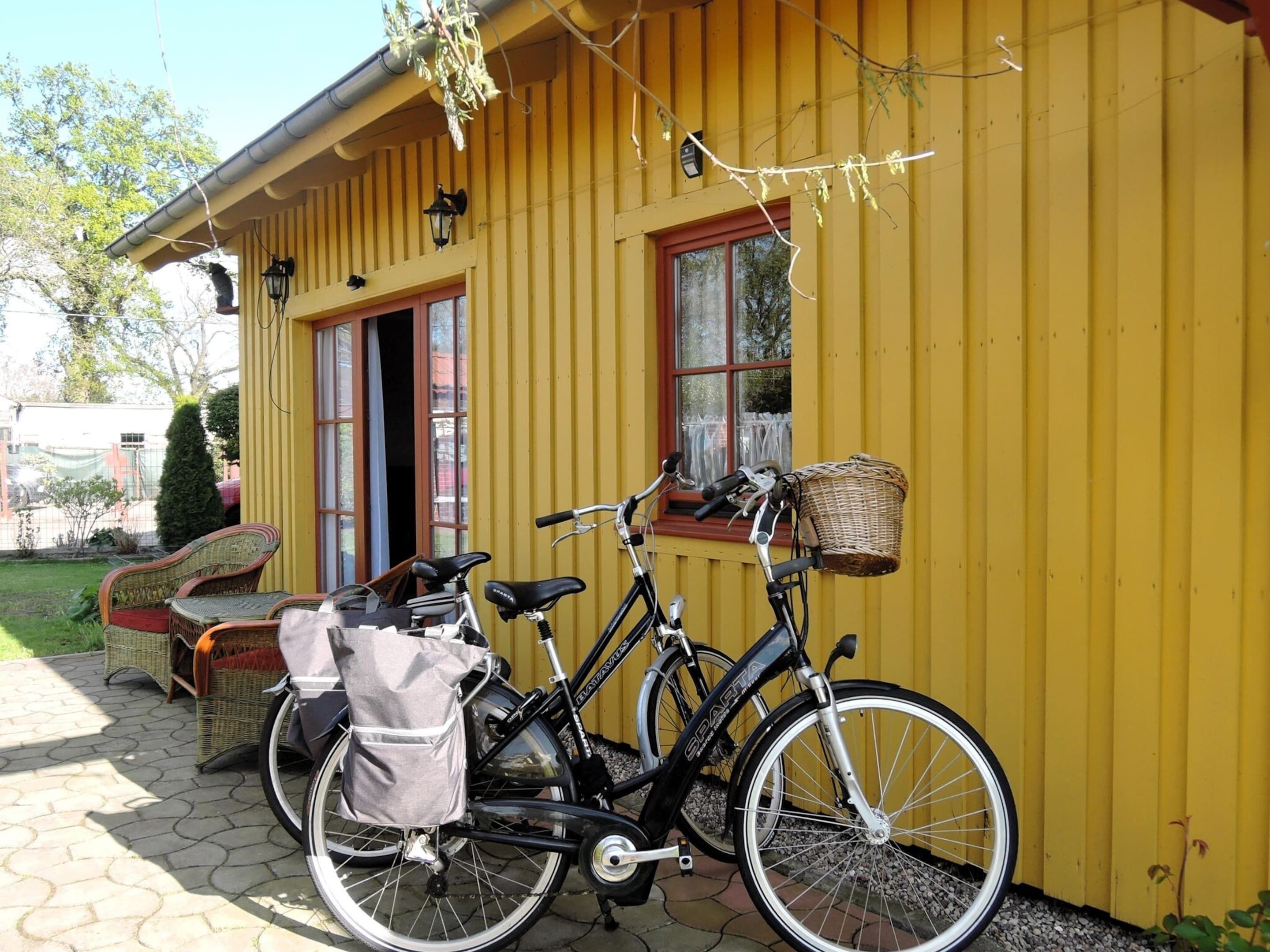 A yellow building with a bicycle parked outside.