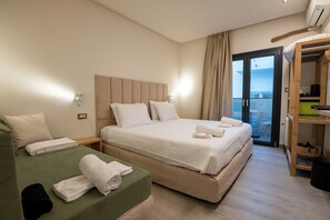 A hotel room with two beds, a balcony, and a wardrobe. - Ocean 11 Hotel (Skiathos)