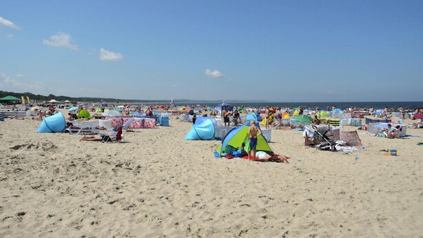 A crowded beach with multiple tents and beachgoers. - Holiday Appartment at the Promenade, Swinoujscie (Swinoujscie)