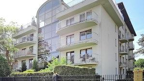 A multi-story residential building with balconies, large windows, and a curved glass facade. - Holiday Appartment at the Promenade, Swinoujscie (Swinoujscie)