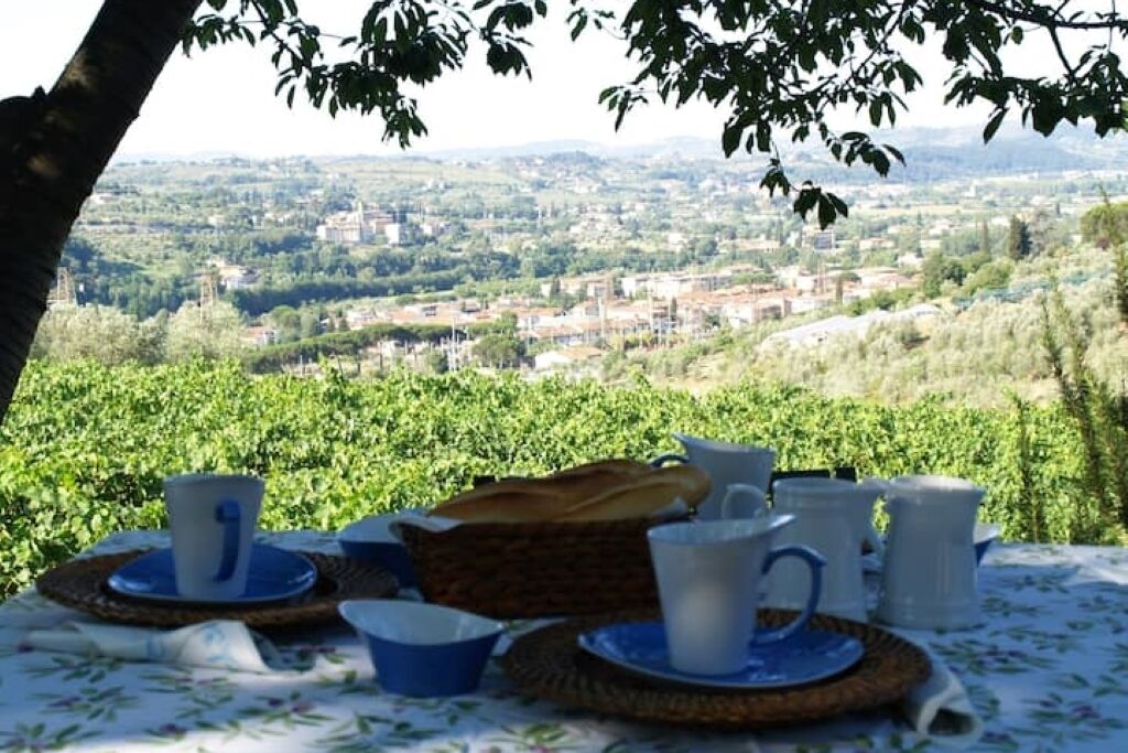 A table set outdoors with a view of a cityscape.