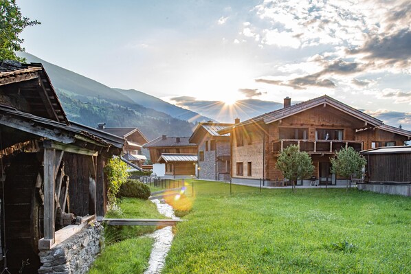 A traditional wooden building with a stone pathway leading to a grassy area. - Chalet in Wald Near Krimml Waterfalls (Wald im Pinzgau)