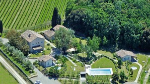 An aerial view of a residential area with multiple houses, a swimming pool, and a road. - Apartment in Tuscany With Golf & Pools (Gambassi Terme)