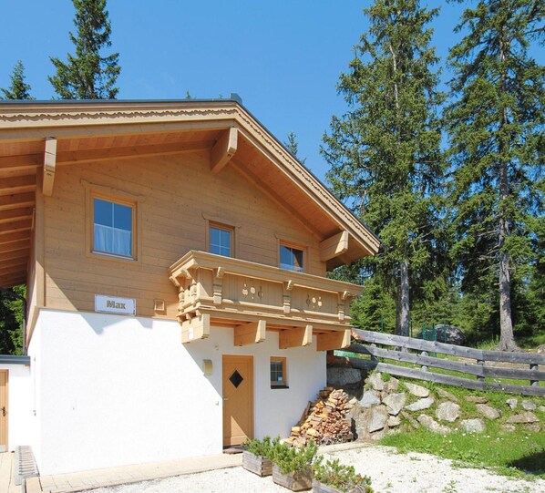 A wooden chalet with a balcony, a nameplate, and a pile of firewood outside. - Chalet in Filzsteinalpe Near Ski Slopes (Krimml)