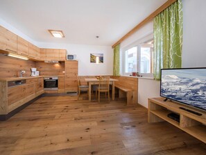 Enjoy a compact apartment with a modern kitchen, dining area, and cozy seating nook.