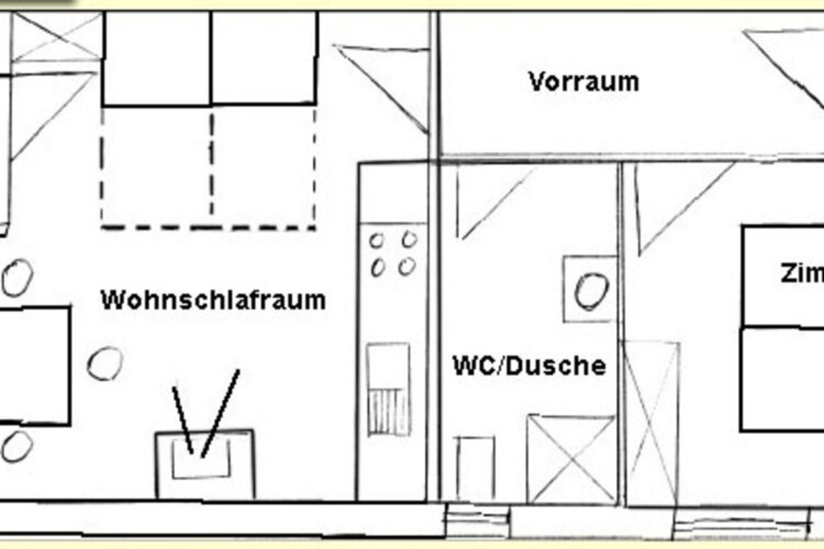 Plano de planta que muestra una sala de estar, cocina, aseo y un dormitorio.
