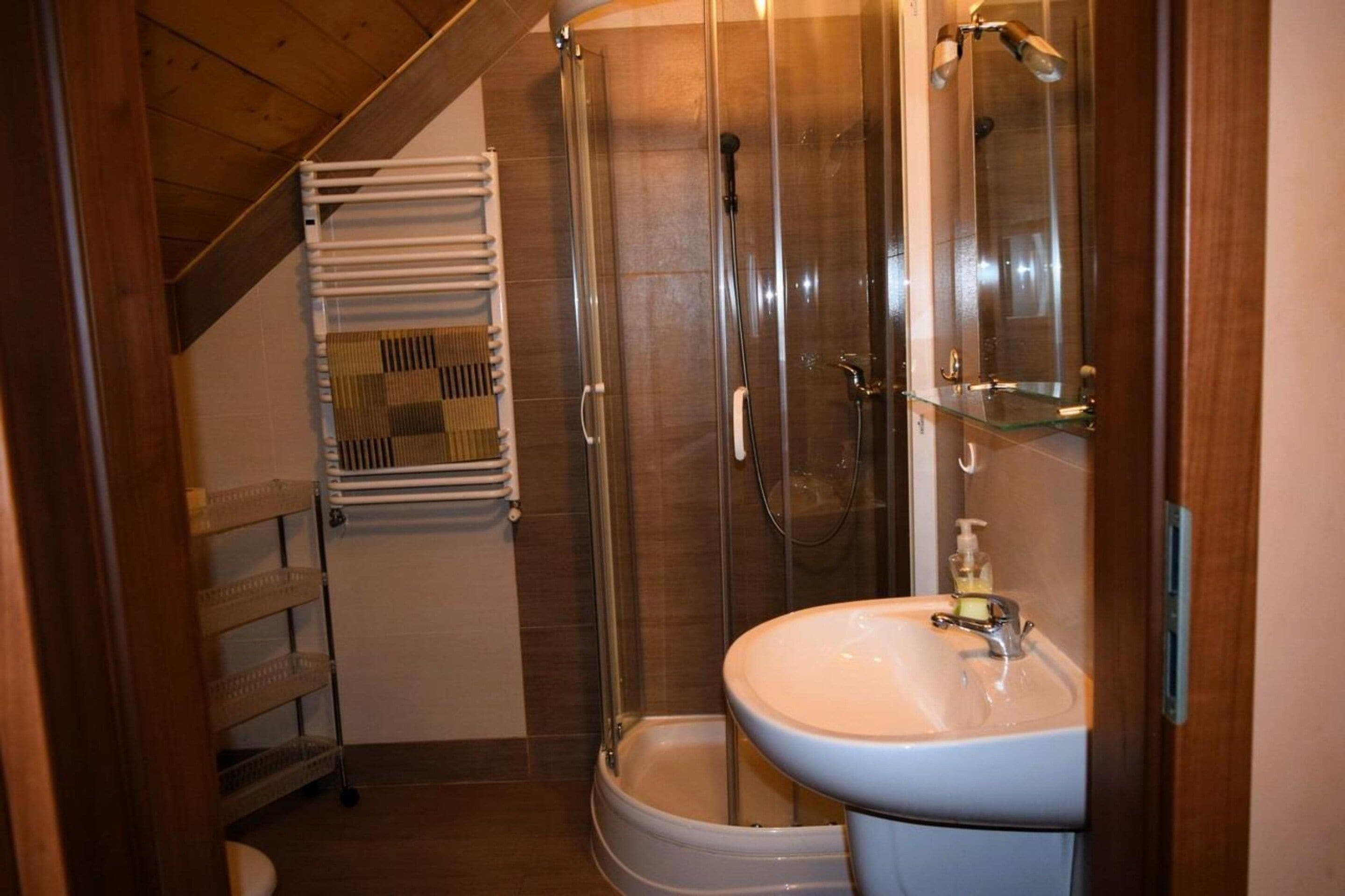 A bathroom with a shower, toilet, and sink.
