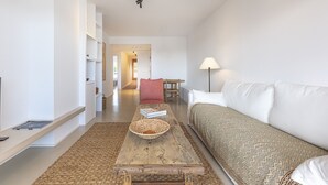 A modern living room with a wooden coffee table, a sofa, and a lamp. - Terrazas de Alcaidesa Golf & Beach 2139 (La Alcaidesa)