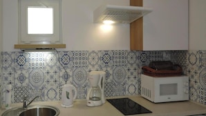 A kitchen with a stainless steel sink, a coffee maker, a microwave, and a toaster. - House in Kolczewo Near Baltic Sea & Lake (gmina Wolin)
