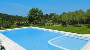 A rectangular swimming pool with a clear blue water surface, surrounded by a concrete deck and a metal safety railing. - Apartment in Tuscany With Pool & Golf (Gambassi Terme)