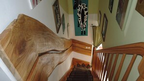 A wooden staircase with a unique design, leading to a landing area with a wooden handrail. - Holiday Home in Nowe Warpno Jagoda (Nowe Warpno)
