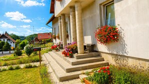 A building with a porch, steps, and flower boxes. - House by Lake Kolczewskie Near Baltic Sea (gmina Wolin)