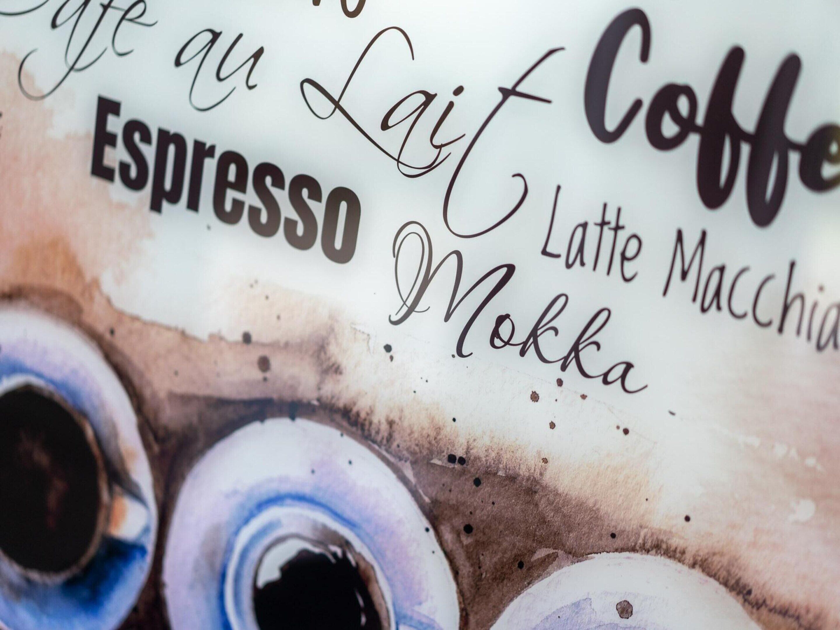 A close-up of a coffee-themed sign with the words "Espresso," "Latte," and "Mokka" visible.