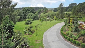 A curved road through a lush green landscape with dense trees and shrubs. - Holiday Home Kolczewo Near Baltic Sea Beach (gmina Wolin)