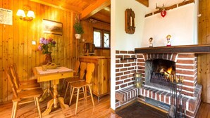 A cozy cabin interior with a wooden dining area, a fireplace, and a bar. - Holiday Home by the Lake, Sauna, Boat, Bicycles (Chmielno)