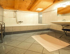 A bathroom with a bathtub, a sink, and a shower. - Chalet in Kitzbuhel Alps Near Hiking Trails (Wildschönau)