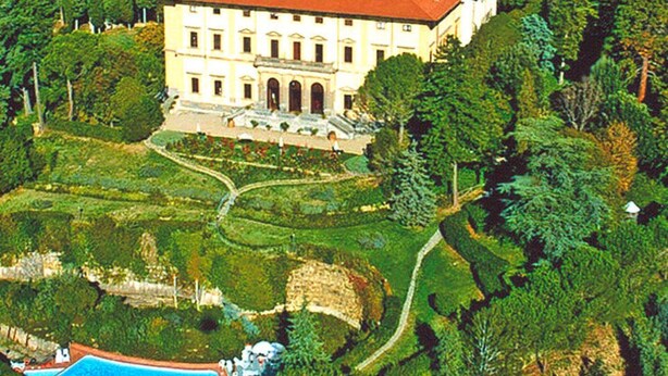 A large, multi-story building with a red roof, surrounded by lush greenery and a swimming pool. - Residence Villa Pitiana at Donnini (Reggello)