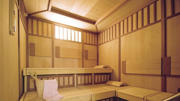 A traditional wooden sauna with benches and a bench with a towel. - Apartment in Milders Near Stubai Glacier (Neustift Im Stubaital)